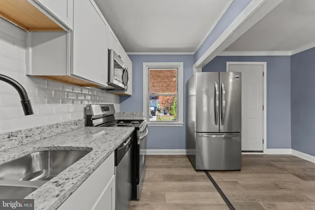 a kitchen with a refrigerator sink and stove