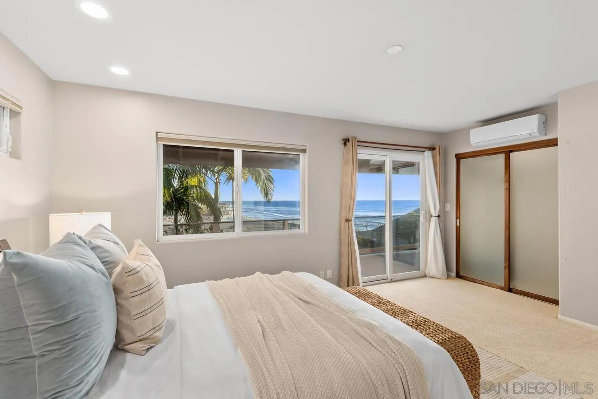 231 5th Street Encinitas, CA 92024 - Photo 23 of 43 a bedroom with a large bed and a window