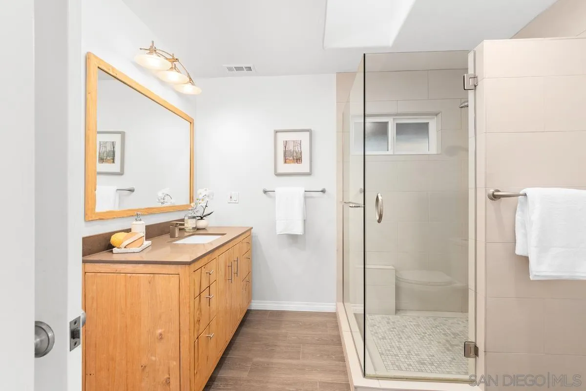 231 5th Street Encinitas, CA 92024 - Photo 26 of 43 a bathroom with a sink a toilet and shower