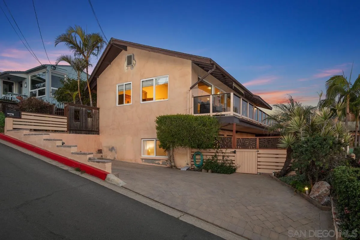 231 5th Street Encinitas, CA 92024 - Photo 39 of 43 a front view of a house with a yard and garage