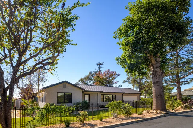 a front view of a house with garden