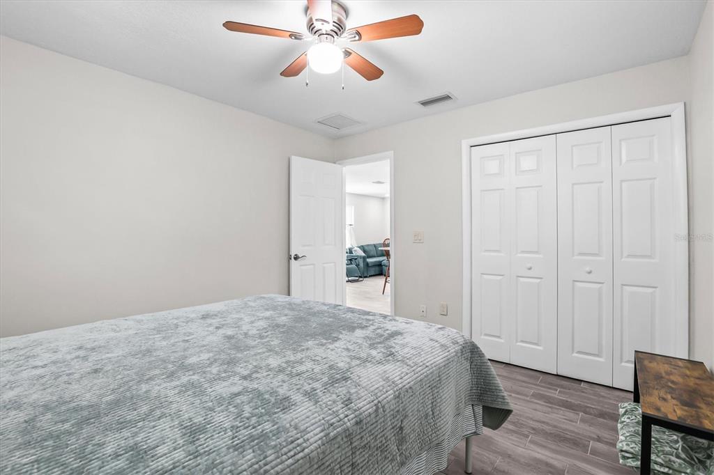 6244 Colony Circle Weeki Wachee, FL 34607 - Photo 51 of 60 a bedroom with a bed and a chandelier fan