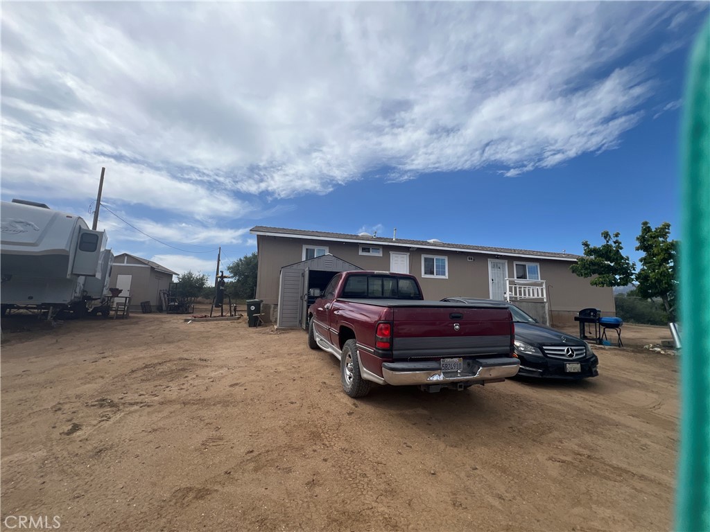 8471 Caughlin Road Phelan, CA 92371 - Photo 1 of 21 a front view of a house with cars parked