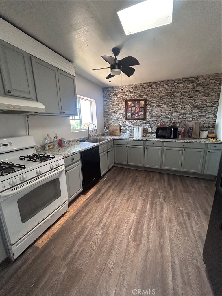8471 Caughlin Road Phelan, CA 92371 - Photo 13 of 21 a kitchen with stainless steel appliances granite countertop a stove and a sink