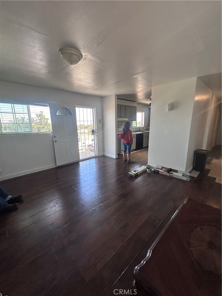8471 Caughlin Road Phelan, CA 92371 - Photo 20 of 21 an empty room with wooden floor and windows