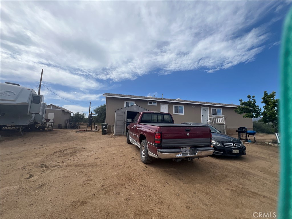 8471 Caughlin Road Phelan, CA 92371 - Photo 3 of 21 a front view of a house with cars parked