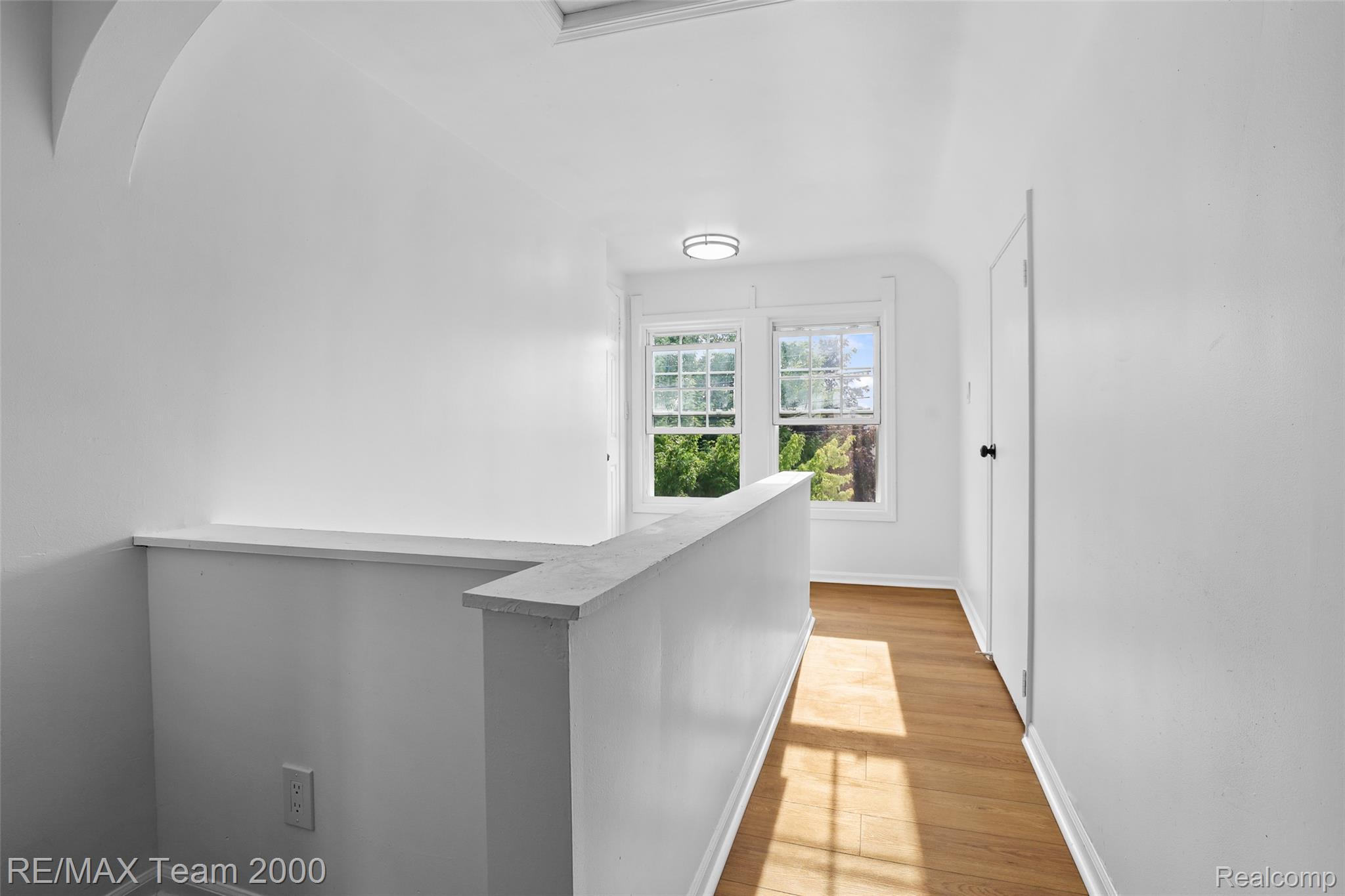 14641 Moran Road Allen Park, MI 48101 - Photo 22 of 36 Hardwood-style flooring, white walls, two casement windows, and a flush-mount ceiling light