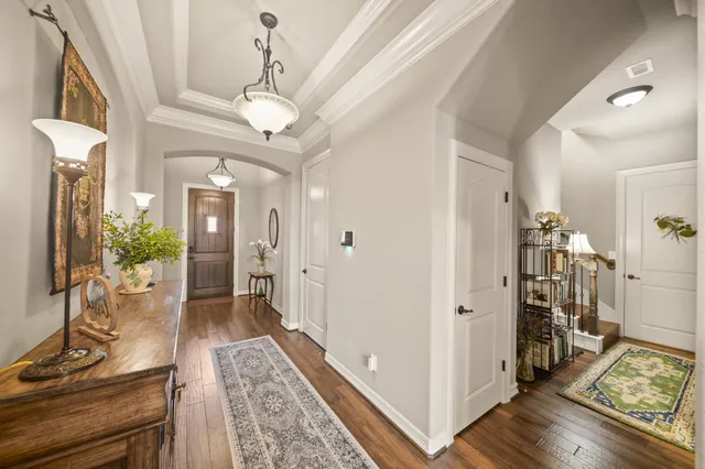 a view of a hallway with workspace and wooden floor