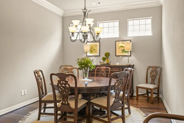 a view of a dining room with furniture and chandelier