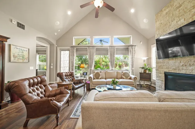 a living room with furniture fireplace and flat screen tv