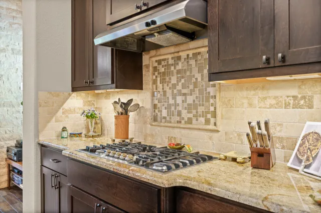 a kitchen with a stove and a cabinets