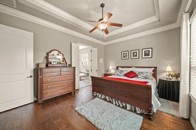 a living room with a bed and a dresser