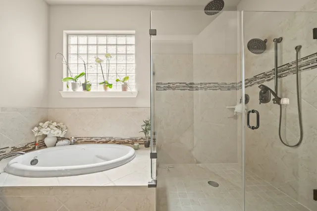 a bathroom with a sink a window and shower