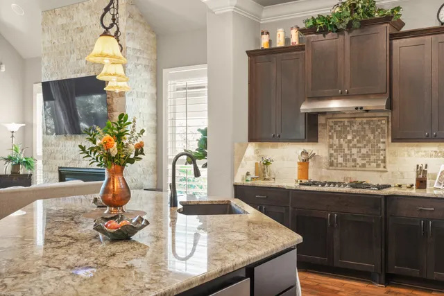 a kitchen with sink refrigerator and microwave