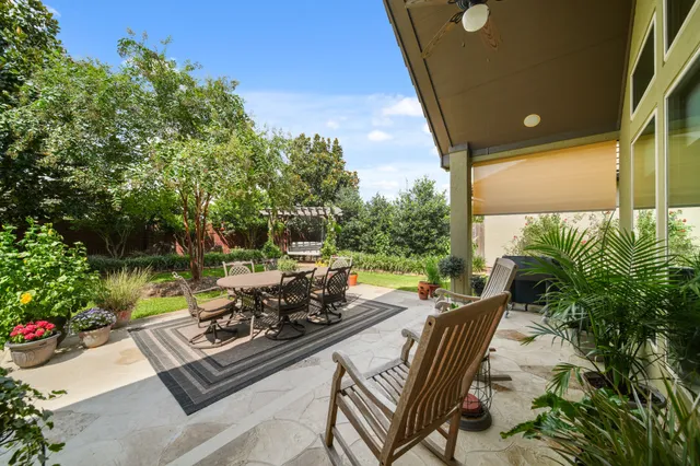 a view of a patio with table and chairs and potted plants