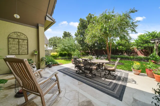 a view of a patio with a table chairs and a fire pit