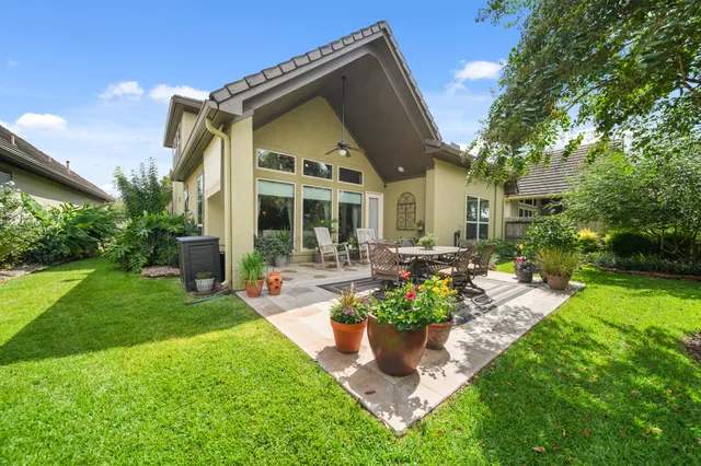 a front view of a house with swimming pool and garden