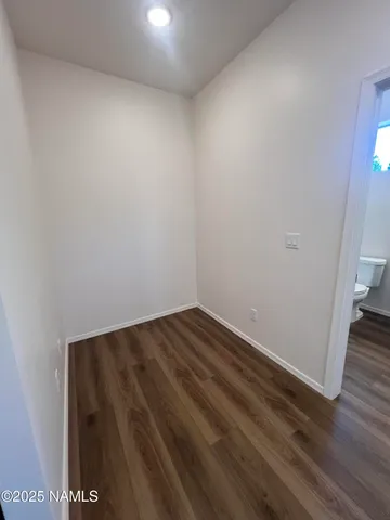 a bathroom with a granite countertop sink a light fixture and a mirror
