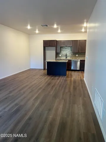 a kitchen with stainless steel appliances granite countertop a stove microwave and cabinets