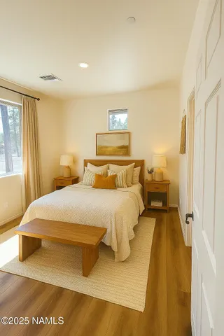 a view of a hallway with wooden floor and entryway