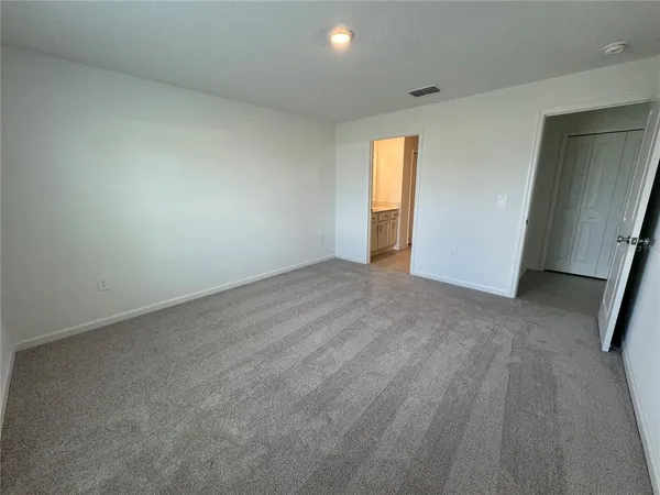 an empty room with windows and closet