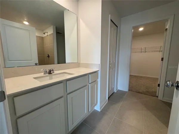 a bathroom with a sink double vanity and a mirror