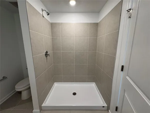 a bathroom with a shower and a toilet