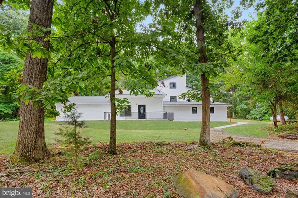 a house that has a big yard with wooden fence