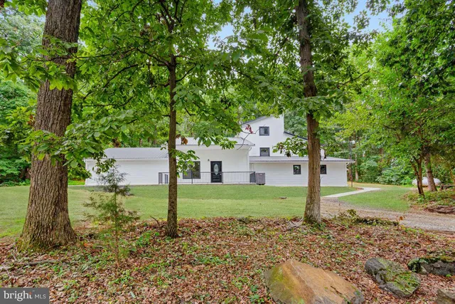a house that has a big yard with wooden fence