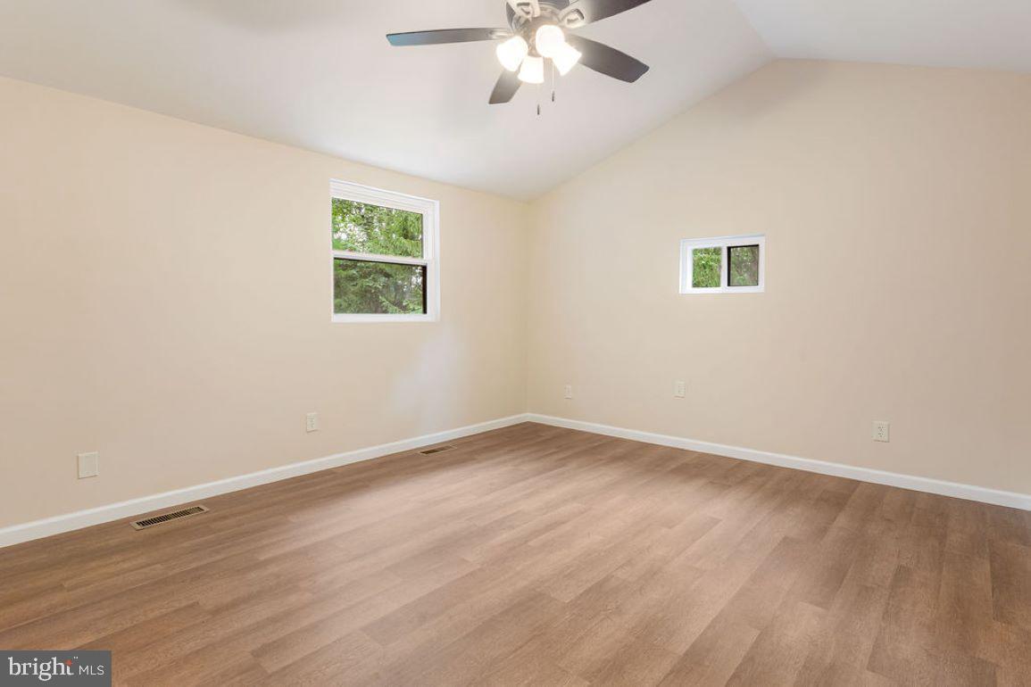 2325 York Road Gettysburg, PA 17325 - Photo 24 of 63 an empty room with wooden floor chandelier fan and windows