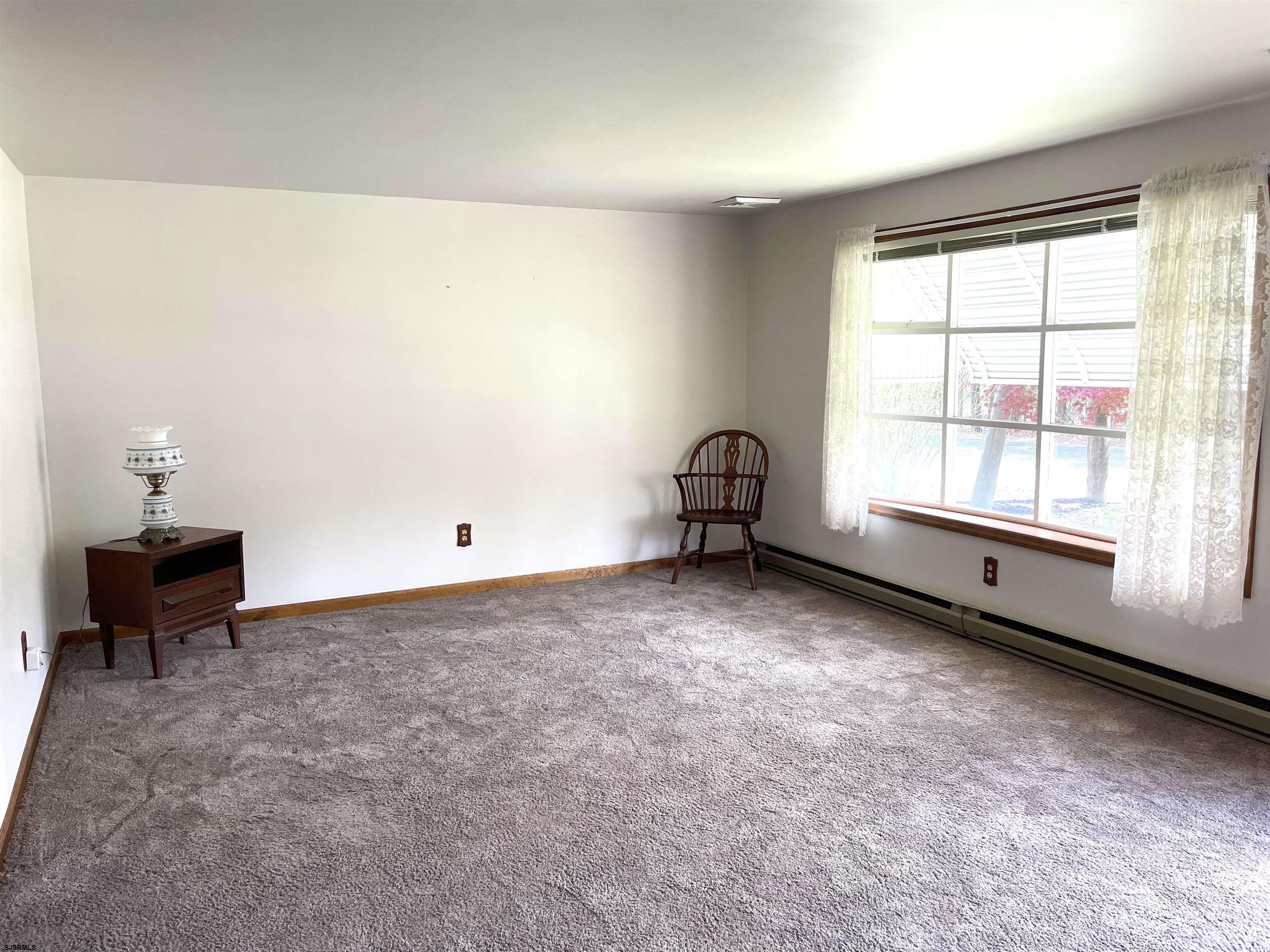 183 Chestnut Neck Road Port Republic, NJ 08241 - Photo 4 of 21 wooden floor in an empty room with a window