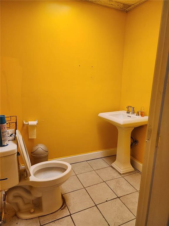 6958 Main Street Lithonia, GA 30058 - Photo 20 of 55 a bathroom with a sink mirror and toilet