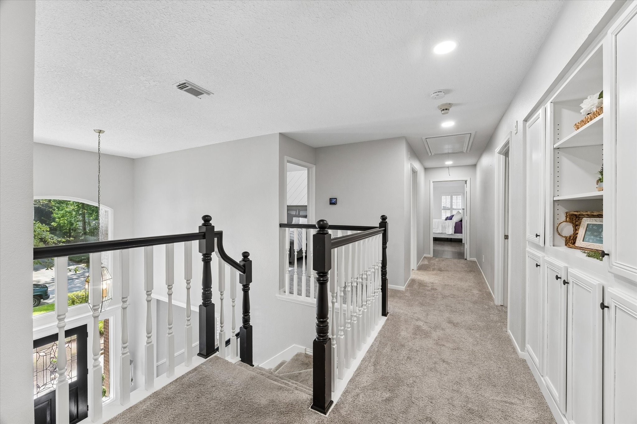 39 Purple Martin Place Spring, TX 77381 - Photo 21 of 43 This is a view as you come out of the larger primary bedroom upstairs and lock down the hall towards the large hall bathroom and the other three bedrooms.