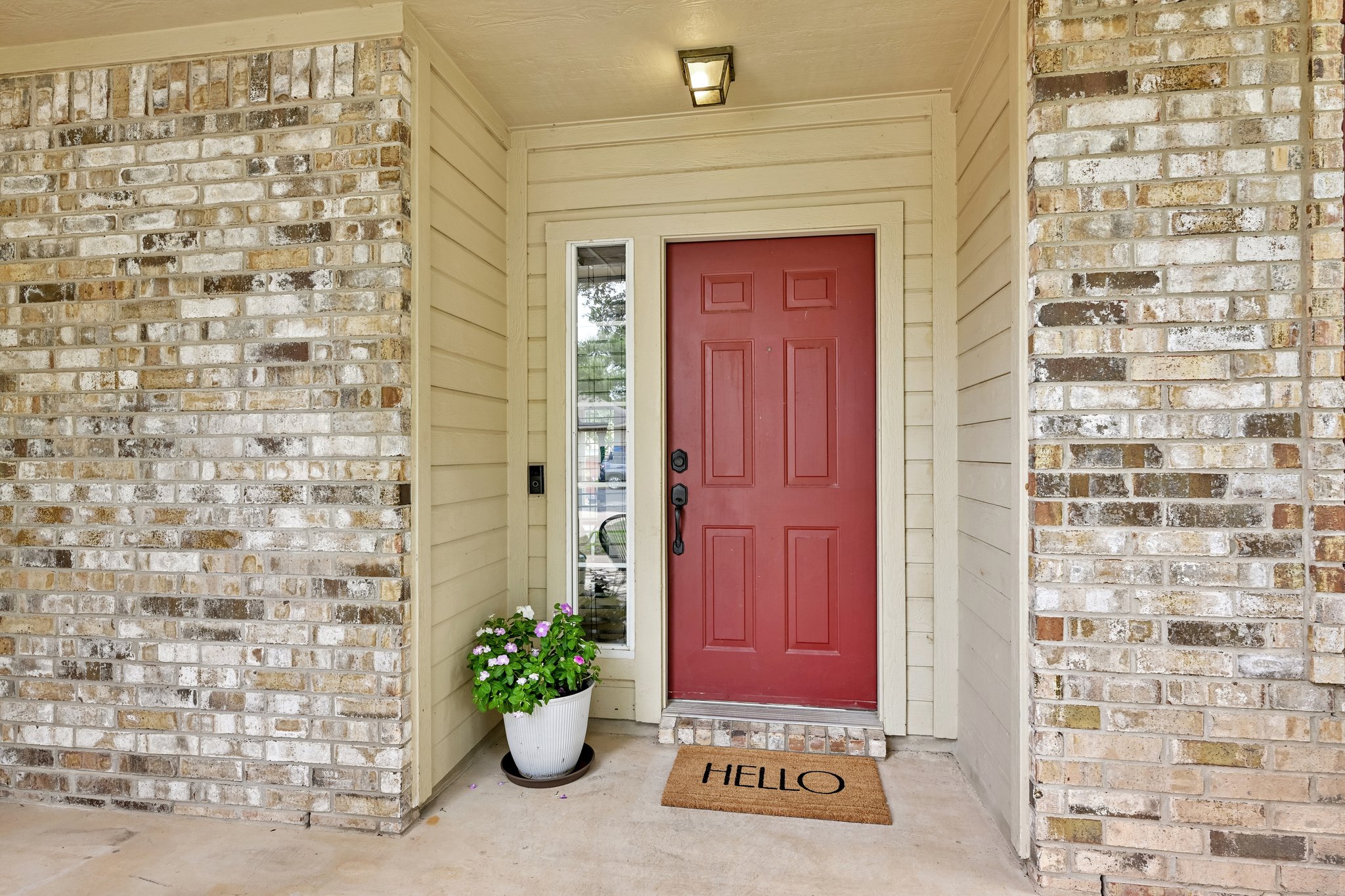4100 Mocha Trail Austin, TX 78728 - Photo 2 of 33 A vibrant red entry door with a side window brightens the brick and siding facade of this welcoming home.