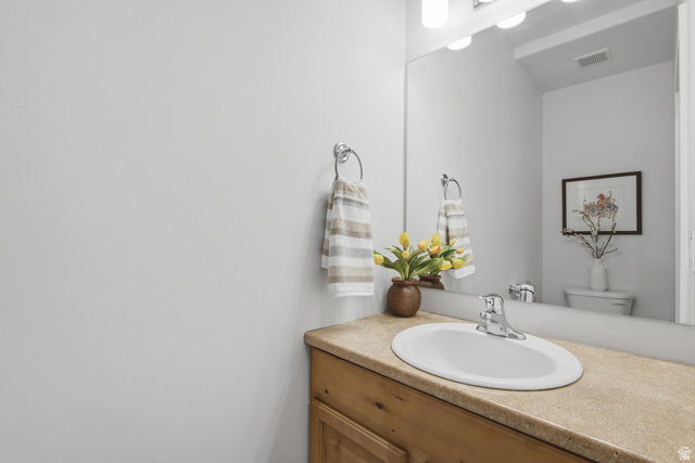 1252 Skyline Road Saratoga Springs, UT 84045 - Photo 27 of 51 Powder room featuring a single-sink vanity with a light wood-finish cabinet and a light-toned countertop