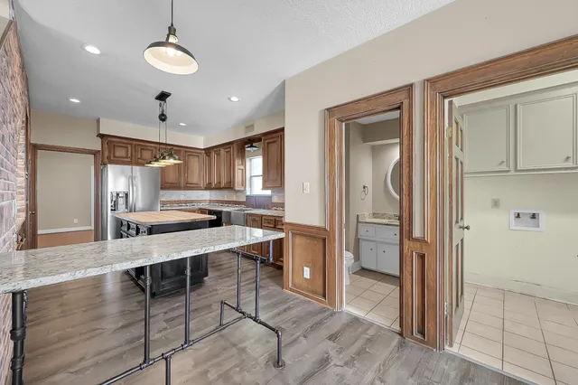 a kitchen with stainless steel appliances granite countertop a sink stove and refrigerator