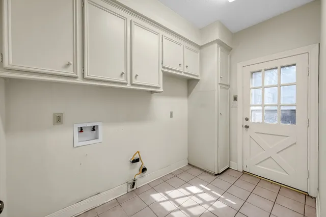 a view of a big house with a big yard and large trees