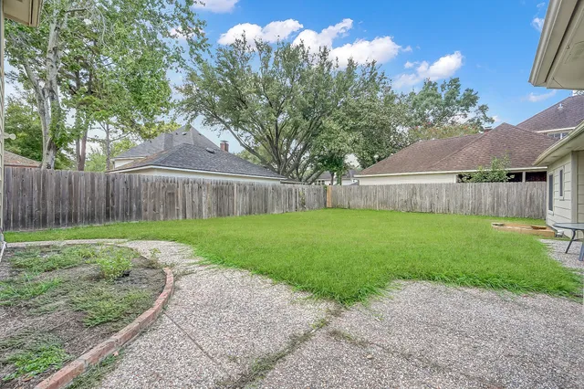 a view of a house with a yard and garden