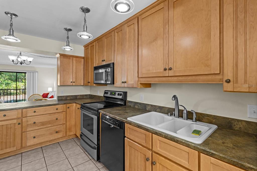 2851 Southwest 32nd Avenue, Unit B6 Ocala, FL 34474 - Photo 14 of 31 a kitchen with granite countertop a sink a stove and cabinets