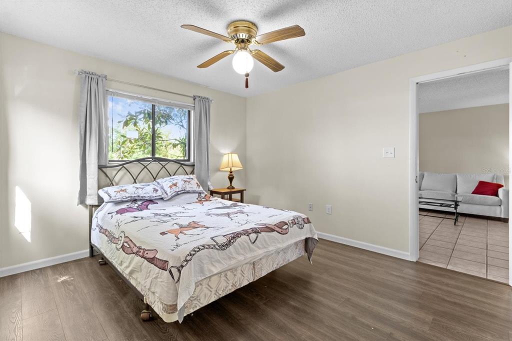 2851 Southwest 32nd Avenue, Unit B6 Ocala, FL 34474 - Photo 16 of 31 a bedroom with a bed and a chandelier
