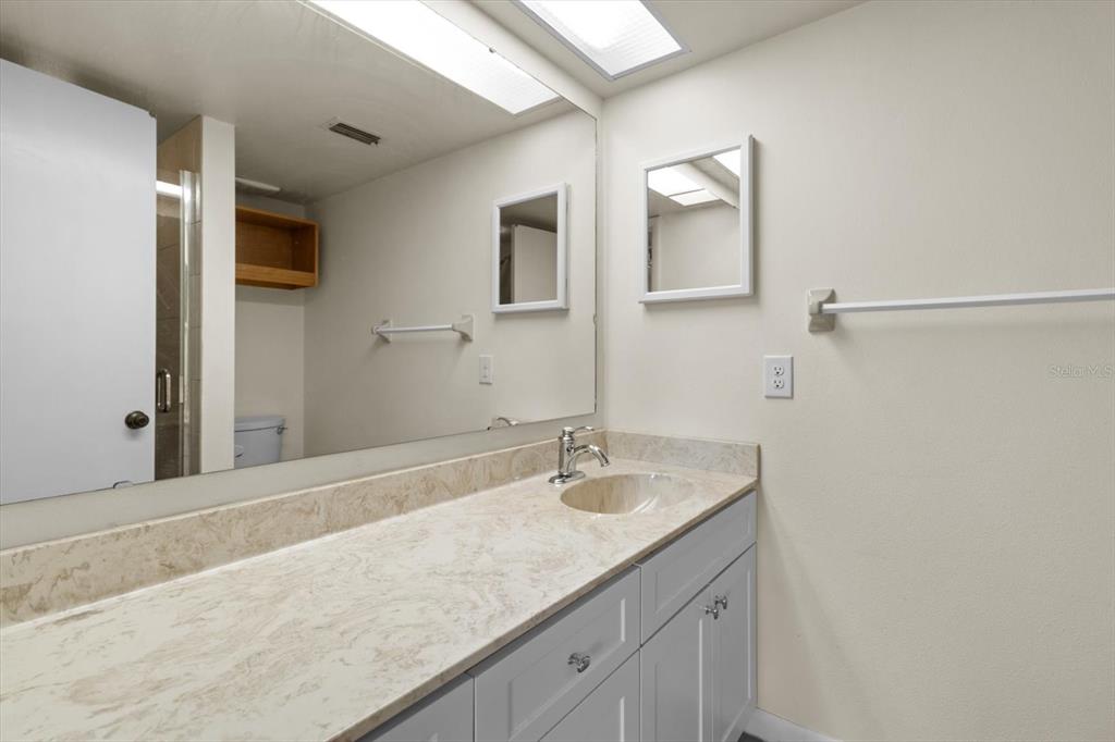 2851 Southwest 32nd Avenue, Unit B6 Ocala, FL 34474 - Photo 19 of 31 a bathroom with a granite countertop sink and a mirror