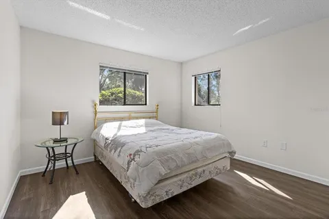 a bedroom with a bed and a chair