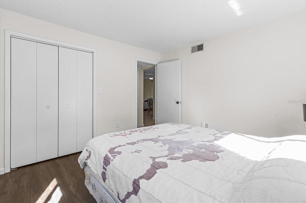 2851 Southwest 32nd Avenue, Unit B6 Ocala, FL 34474 - Photo 23 of 31 a bedroom with a bed and wooden floor