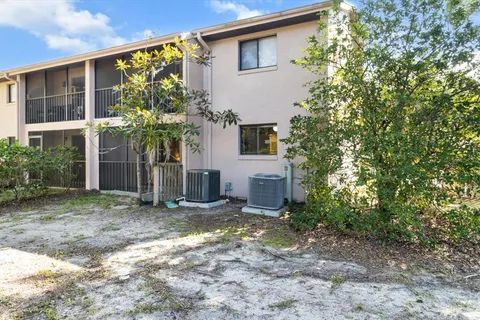 a view of a house with a yard and potted plants