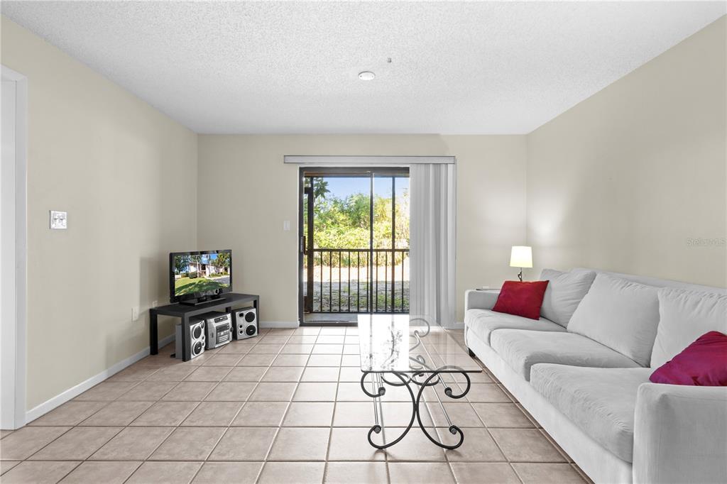 2851 Southwest 32nd Avenue, Unit B6 Ocala, FL 34474 - Photo 6 of 31 a living room with furniture and a flat screen tv