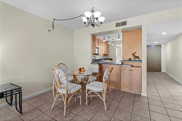 a view of a dining room with furniture and a chandelier