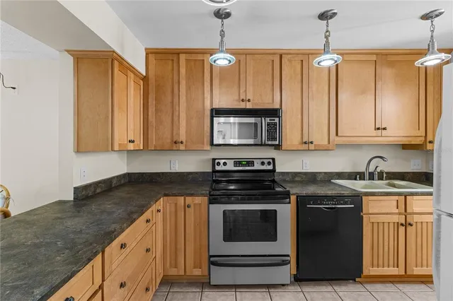 a kitchen with stainless steel appliances granite countertop a stove a sink and a granite counter tops