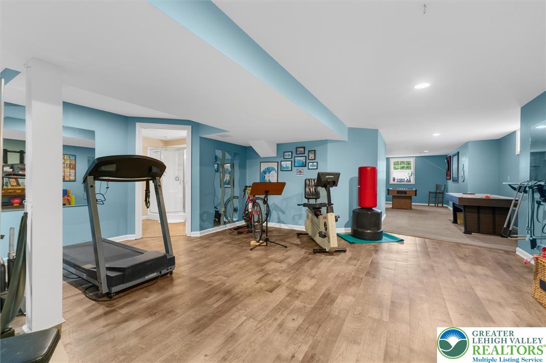 5616 Snowdrift Road Orefield, PA 18069 - Photo 28 of 36 A well-lit recreational space featuring durable laminate flooring and a dedicated fitness zone.