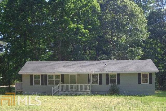 930 Burson Maddox Road Winder, GA 30680 - Photo 1 of 1 a front view of a house with a garden and tree