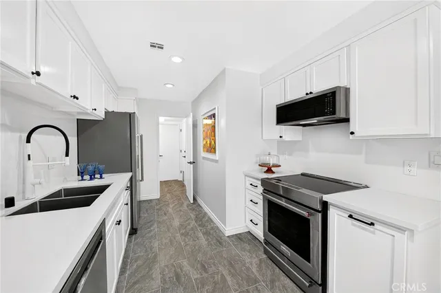 a kitchen with a sink stove and microwave